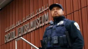 Shutterstock Man in a uniform stands in foreground in blur with the Jewish museum behind himShutterstock